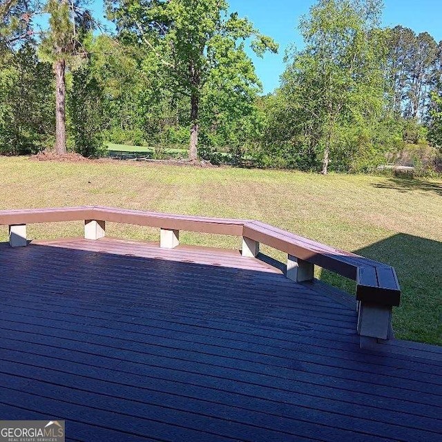 wooden terrace with a lawn