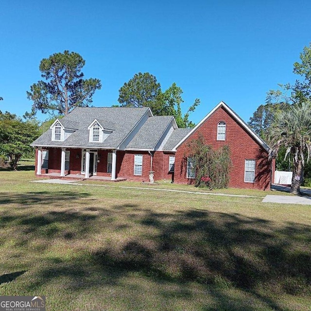 view of front of house featuring a front yard and brick siding