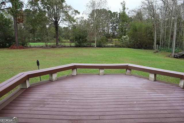 wooden deck featuring a yard