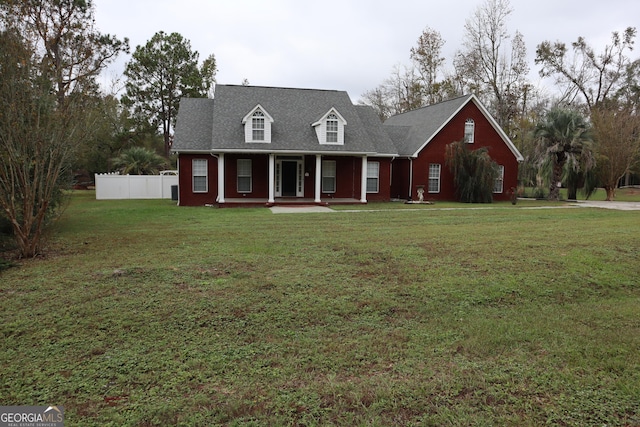 cape cod house featuring a front yard, a porch, and fence