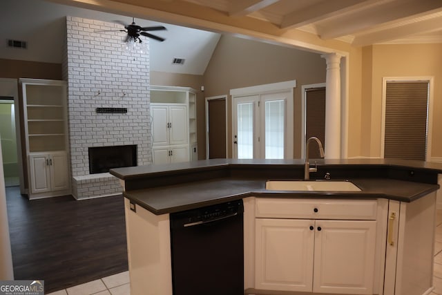 kitchen with black dishwasher, dark countertops, a sink, and visible vents