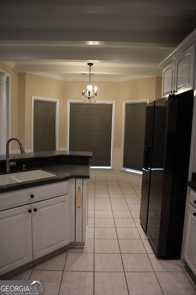 kitchen with dark countertops, hanging light fixtures, black refrigerator with ice dispenser, a sink, and light tile patterned flooring