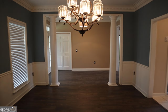 unfurnished dining area featuring wood finished floors, decorative columns, and ornamental molding