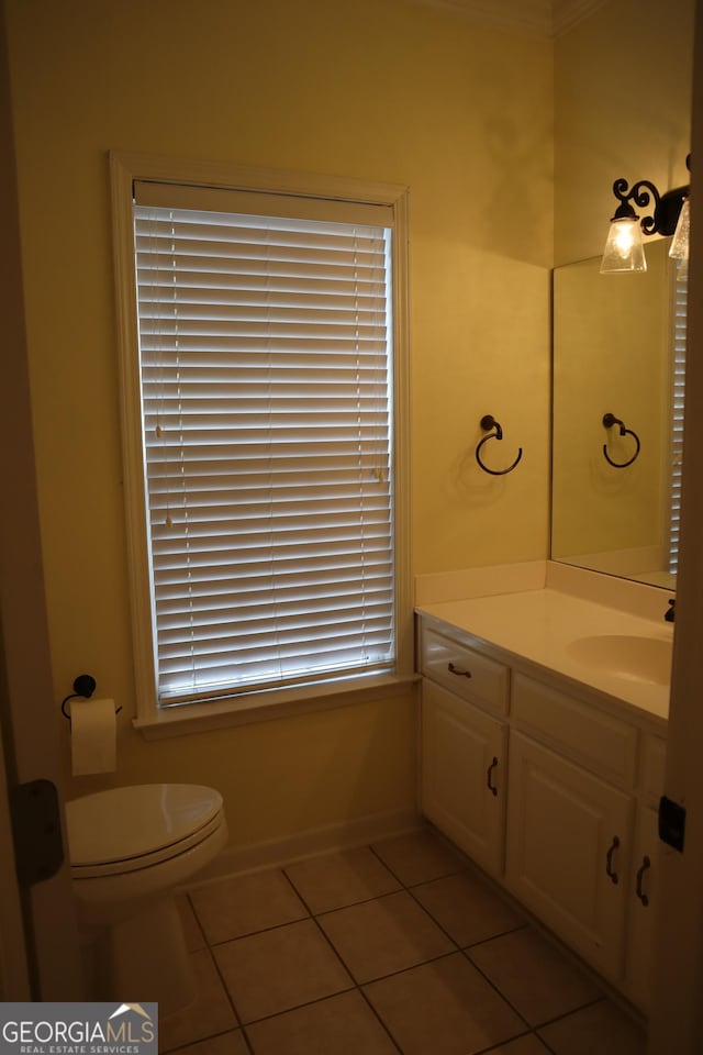 half bath featuring toilet, tile patterned flooring, and vanity