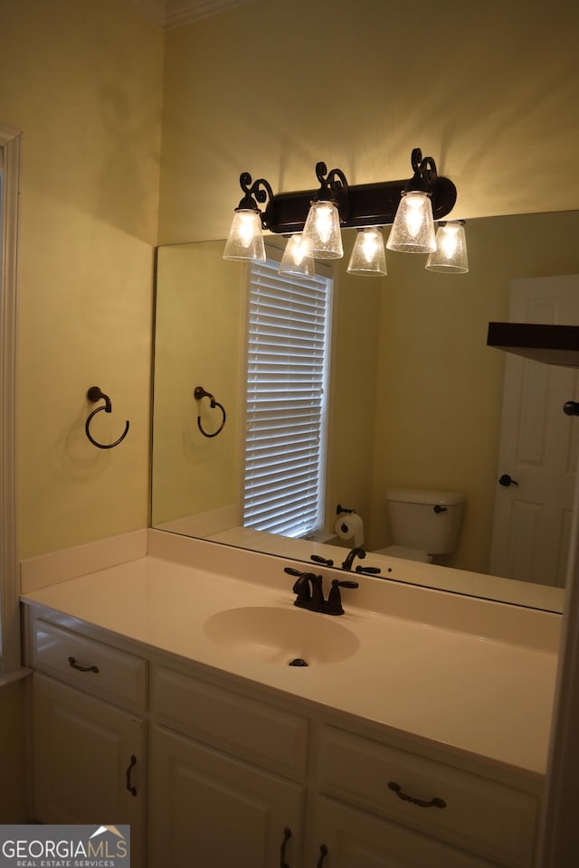 bathroom featuring toilet and vanity