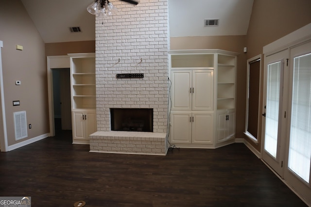 unfurnished living room with visible vents, vaulted ceiling, and dark wood finished floors