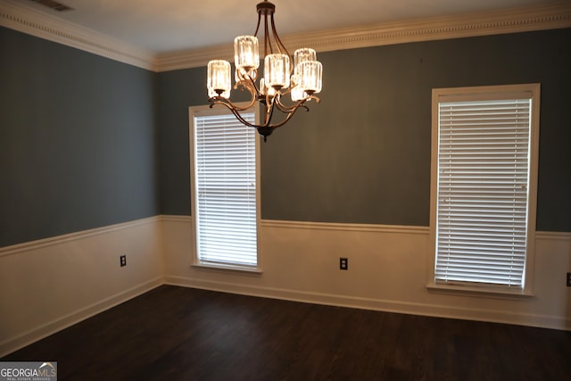 unfurnished room featuring dark wood-style flooring, a notable chandelier, ornamental molding, and a wainscoted wall