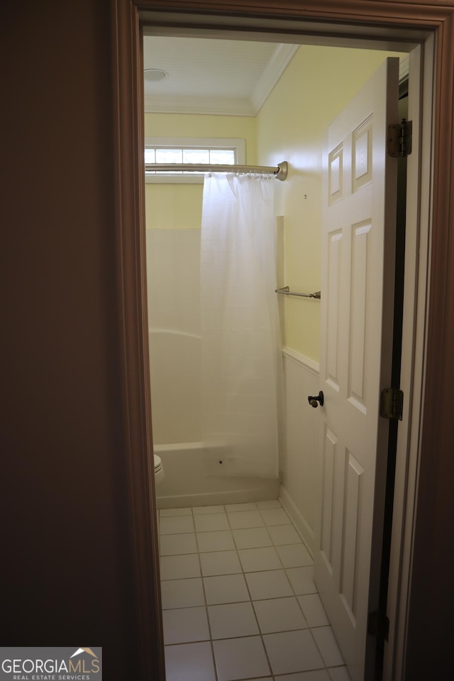 full bath with wainscoting, ornamental molding, and tile patterned floors