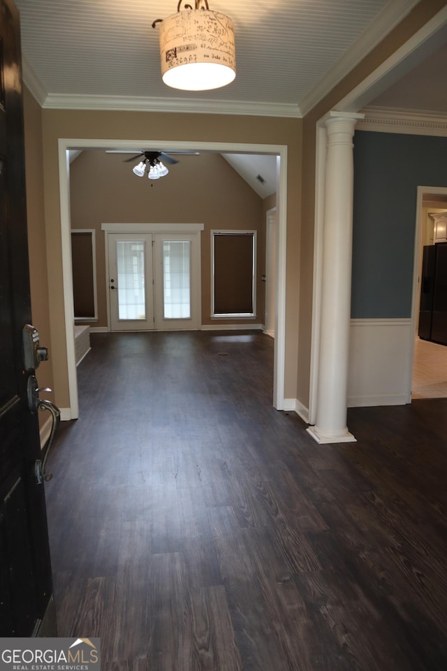 foyer entrance with dark wood-style flooring, baseboards, ornamental molding, a ceiling fan, and decorative columns