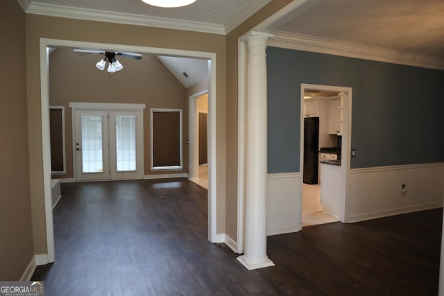 foyer entrance with dark wood-type flooring, ornate columns, ceiling fan, and wainscoting