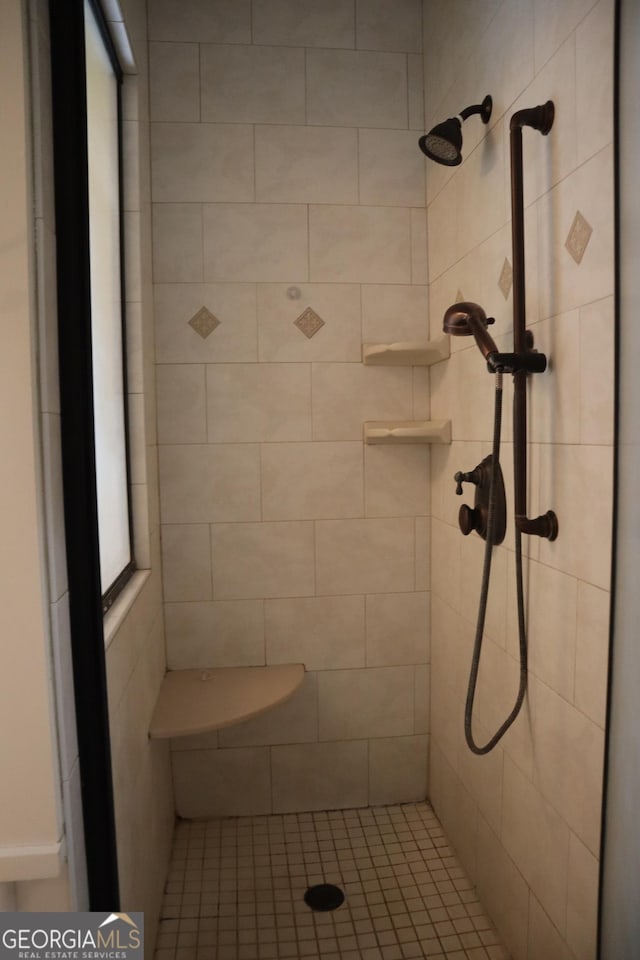 bathroom with a tile shower