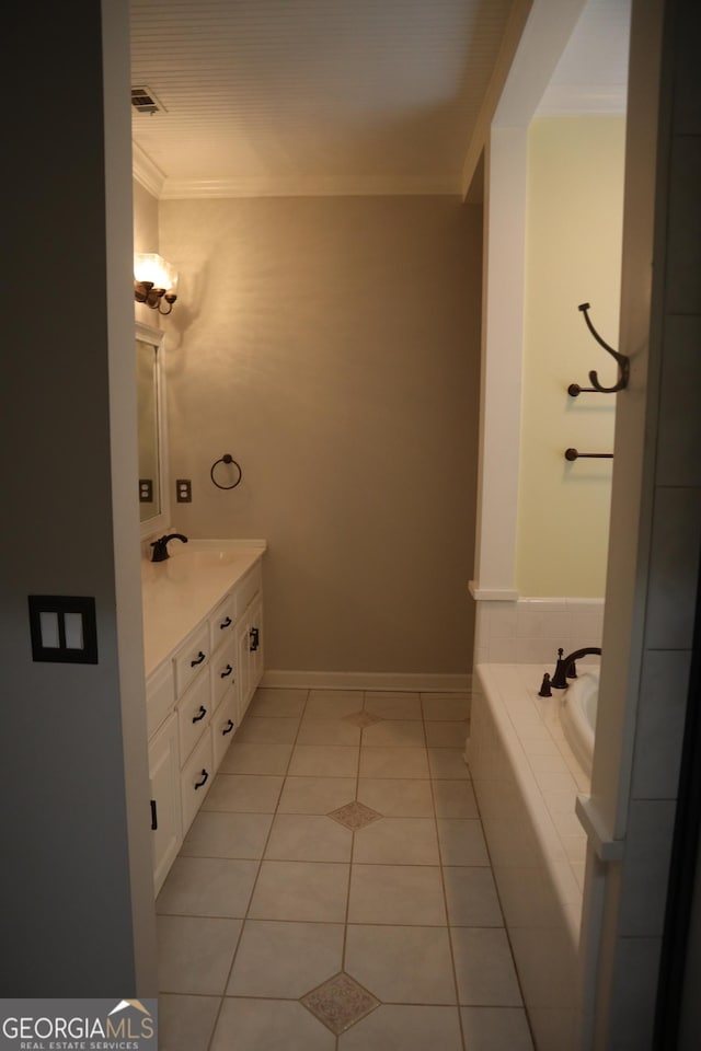 bathroom with a sink, baseboards, tile patterned floors, double vanity, and crown molding