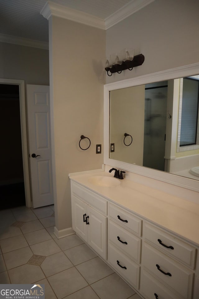bathroom featuring vanity, baseboards, ornamental molding, and tile patterned flooring