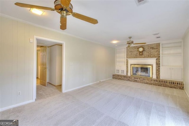 unfurnished living room with visible vents, built in features, ornamental molding, carpet floors, and a brick fireplace