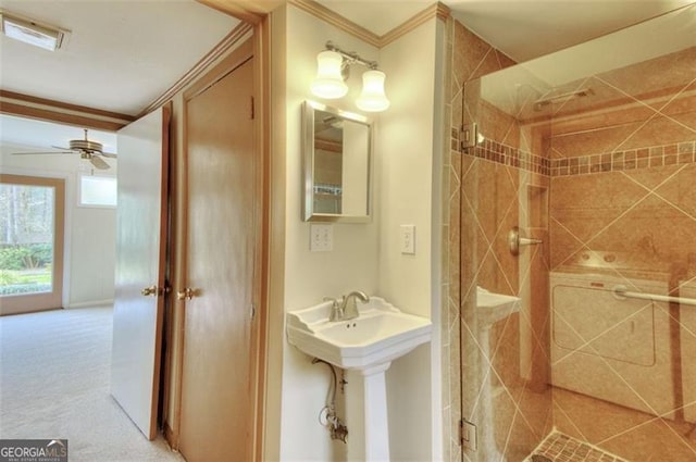 full bathroom with visible vents, ornamental molding, a ceiling fan, a sink, and a shower stall