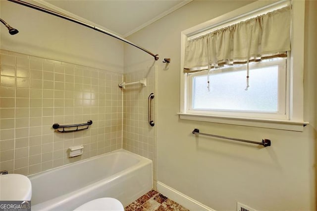 full bathroom featuring ornamental molding, baseboards, bathing tub / shower combination, and toilet