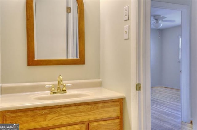 bathroom with wood finished floors, vanity, and a ceiling fan