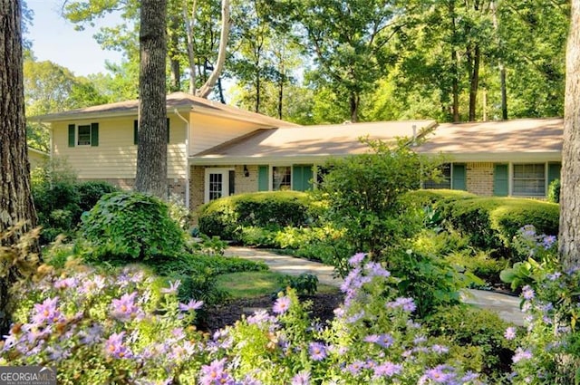 tri-level home featuring brick siding