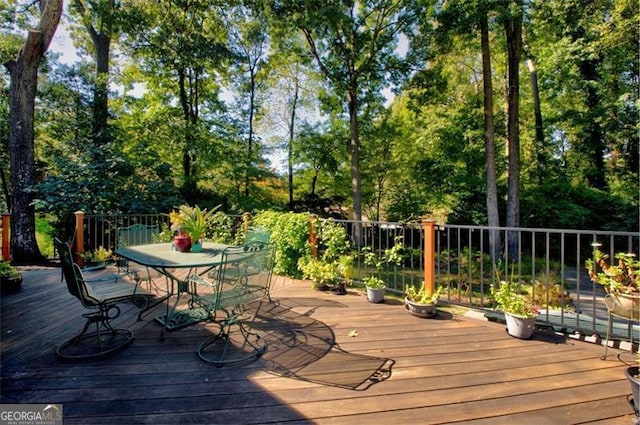 wooden deck featuring outdoor dining space