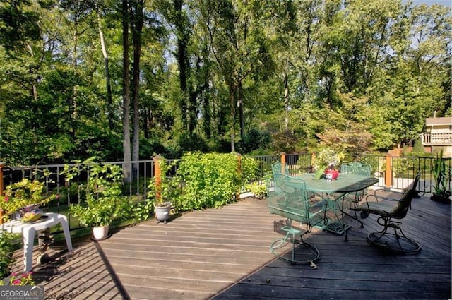 wooden terrace featuring outdoor dining space