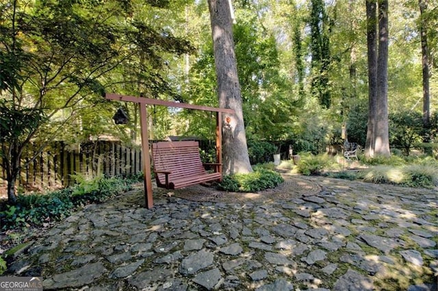 surrounding community featuring a patio area and fence