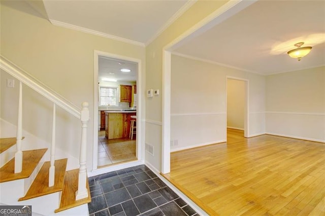 entrance foyer featuring stairway, visible vents, dark wood-style flooring, and crown molding