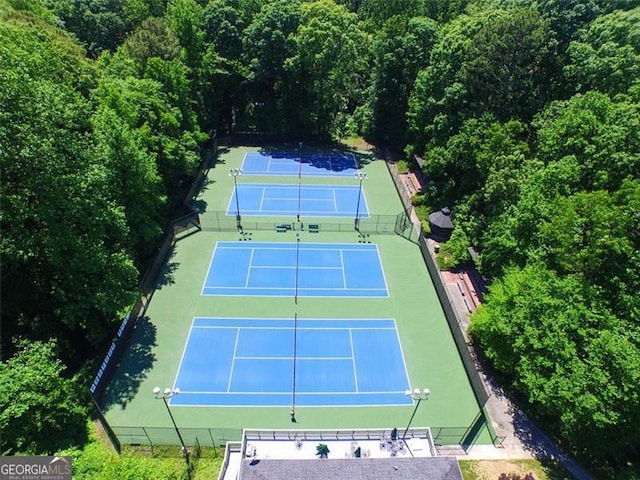 view of tennis court featuring fence