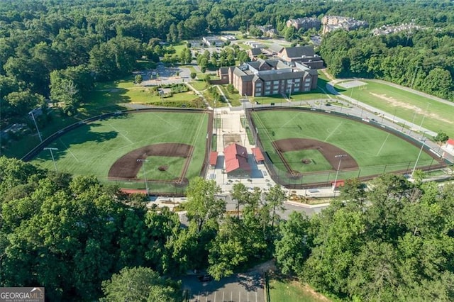 birds eye view of property featuring a wooded view