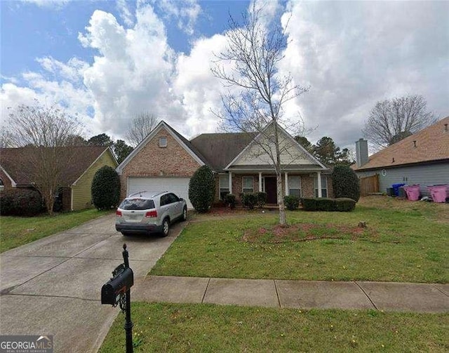 view of front of house featuring a garage, a front yard, brick siding, and driveway