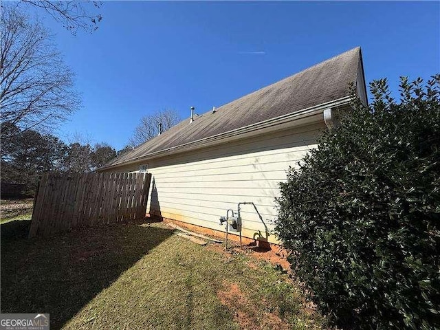 view of side of property featuring fence