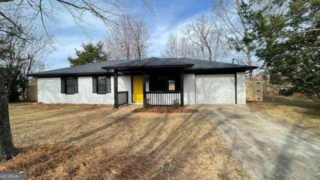 single story home featuring an attached garage and driveway