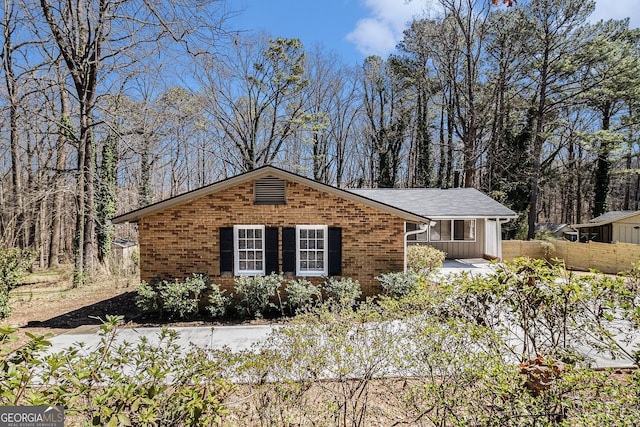 ranch-style home with brick siding and fence