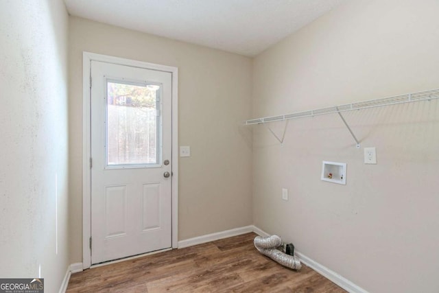 washroom with laundry area, hookup for a washing machine, baseboards, and wood finished floors