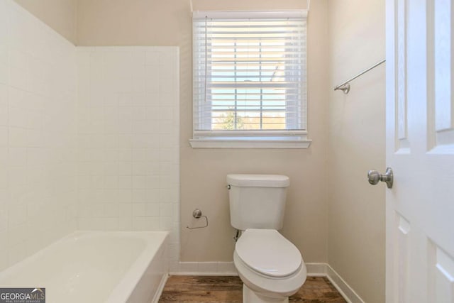 full bath with toilet, baseboards, and wood finished floors