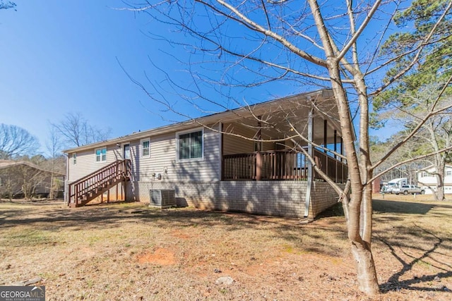 rear view of property featuring central AC