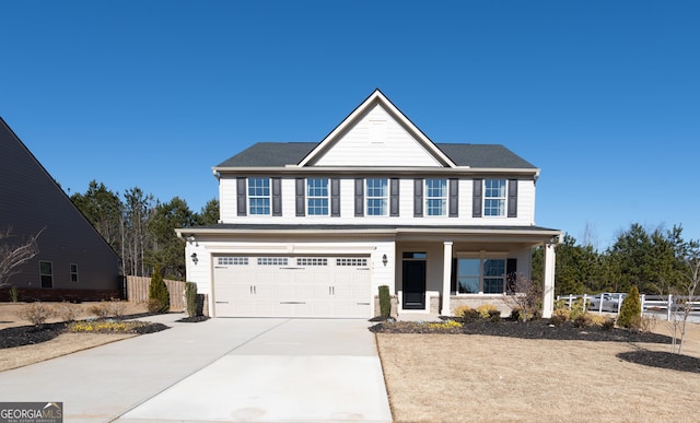 view of front of house with a garage, covered porch, fence, and driveway