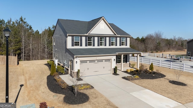 view of front of house with a garage, driveway, a shingled roof, and fence