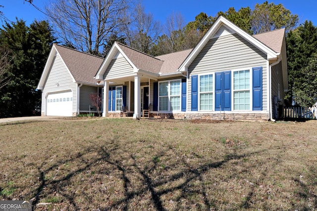 ranch-style home featuring a garage, stone siding, roof with shingles, and a front yard