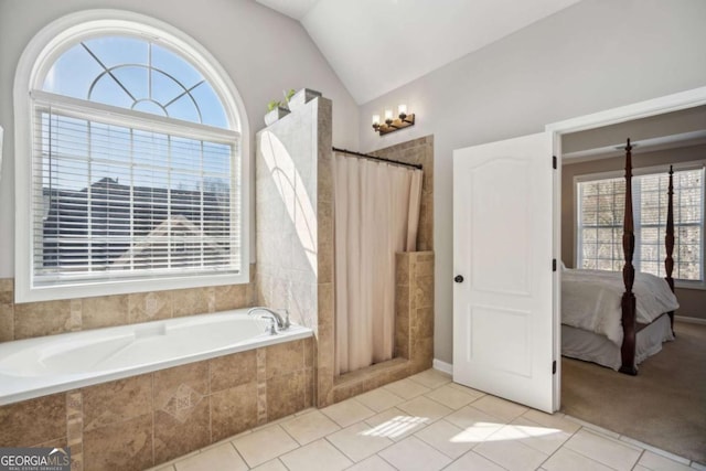 ensuite bathroom featuring tile patterned floors, plenty of natural light, connected bathroom, and lofted ceiling