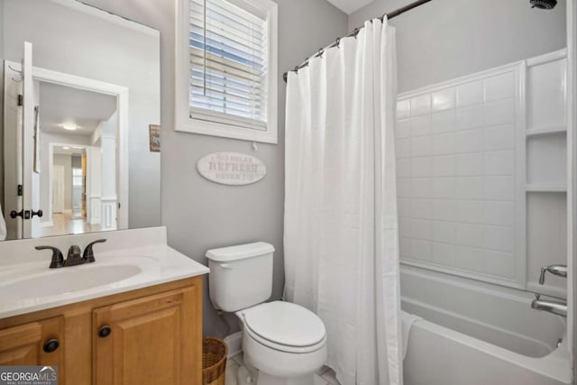 bathroom featuring vanity, shower / tub combo, and toilet