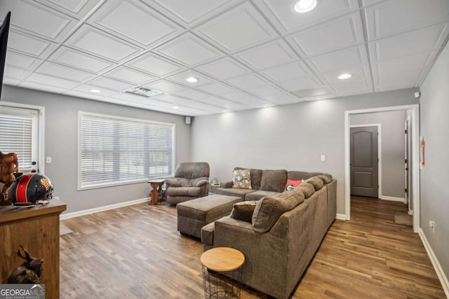 living area featuring recessed lighting, baseboards, and wood finished floors