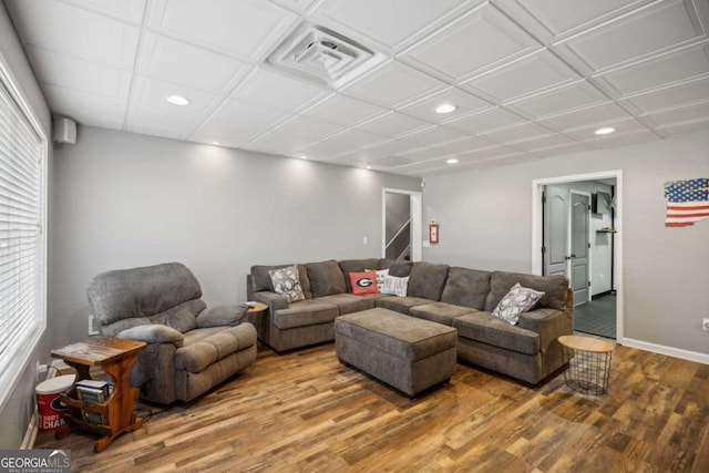 living area featuring visible vents, baseboards, stairs, recessed lighting, and wood finished floors