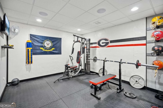 exercise room featuring recessed lighting, baseboards, a paneled ceiling, and visible vents