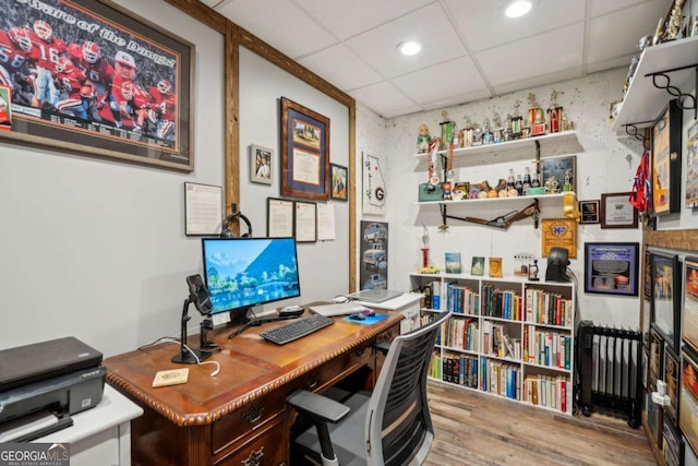 home office featuring wood finished floors, recessed lighting, and a paneled ceiling