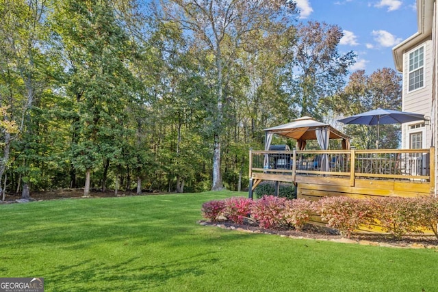 view of yard featuring a gazebo and a deck