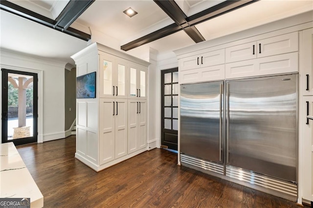 kitchen with dark wood finished floors, white cabinetry, crown molding, beamed ceiling, and stainless steel built in refrigerator