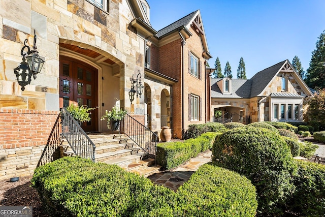 exterior space with stone siding and brick siding