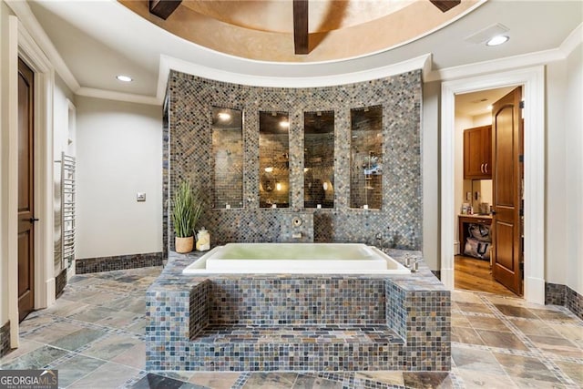 full bath featuring baseboards, ornamental molding, stone tile floors, recessed lighting, and a bath