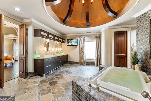 full bathroom featuring vanity, a tray ceiling, baseboards, and ornamental molding