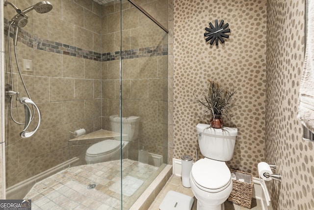 full bathroom with toilet and a tile shower